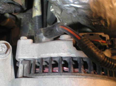 2000 Ford Excursion - Close-up view of an alternator, a critical component for vehicle electrical systems.