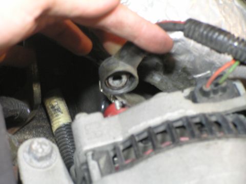2000 Ford Excursion - Close-up view of an automotive alternator with visible wiring and mounting hardware.