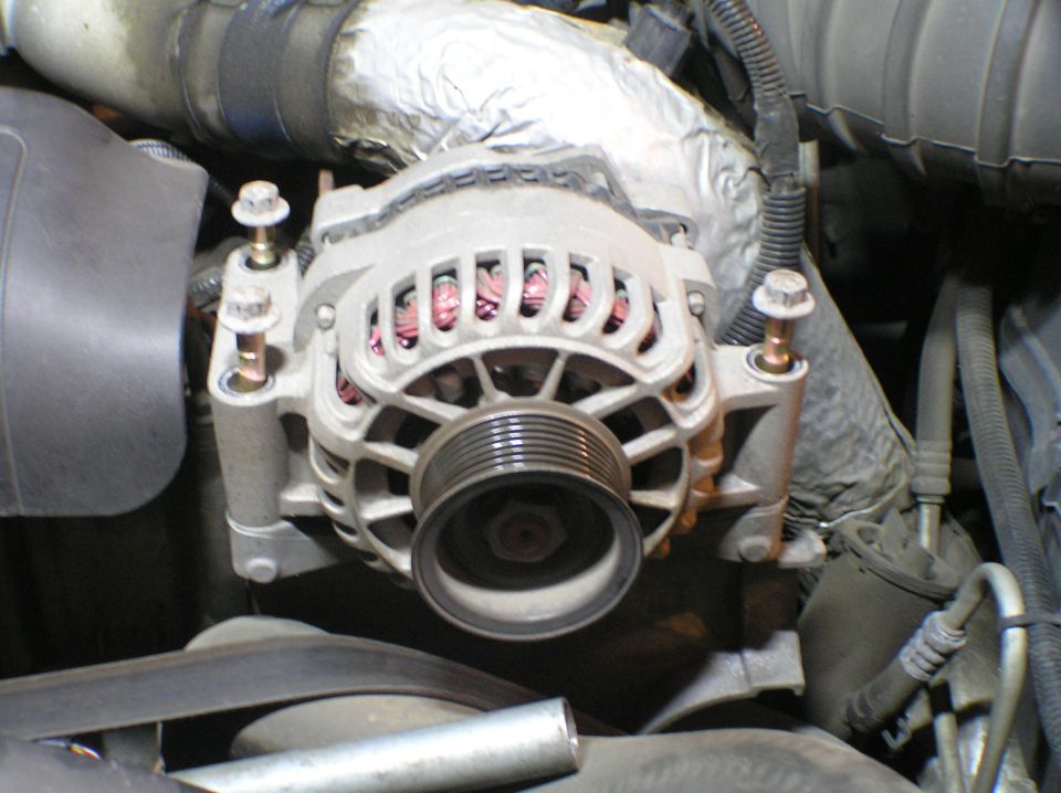 Alternator with serpentine pulley mounted in an engine bay