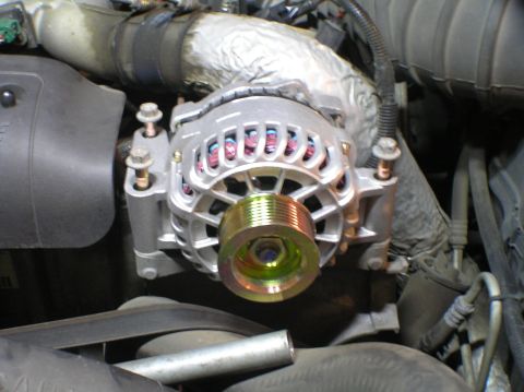 2000 Ford Excursion - Close-up view of a vehicle's alternator, a prominent pulley.