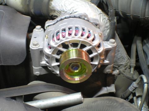 2000 Ford Excursion - New alternator installed in engine bay, showing the pulley and wiring.