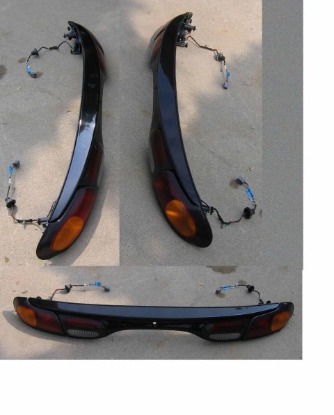2000 Ford Taurus - These car taillights are laid out on a concrete surface, showing their design and wiring.