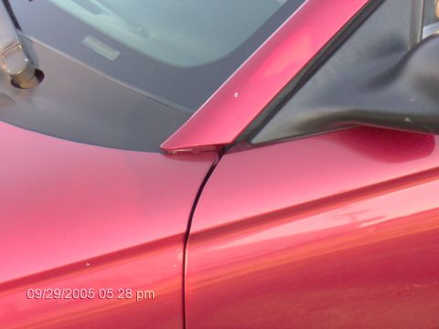 1996 Ford Mustang - This photo shows a close-up of a red car's side mirror and door panel, with a timestamp from 2005.