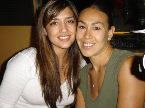 Two smiling women, one with long brown hair, the other with dark hair pulled back. "SUPERMOTORS" logo visible