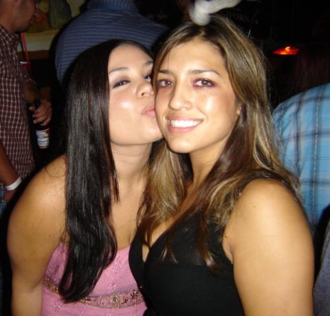 2004 Ford F-150 - A woman in a pink dress kisses another woman on the cheek while posing for a photo indoors.