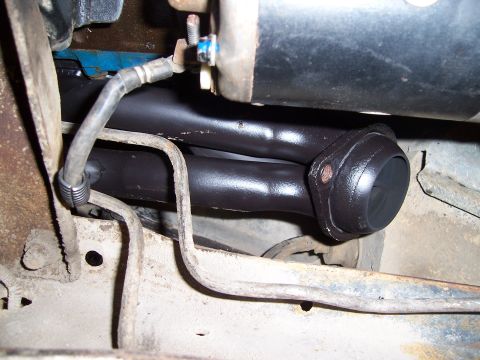 1983 Ford Bronco - Close-up view of an exhaust manifold and starter motor assembly.