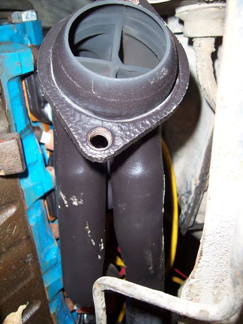 1983 Ford Bronco - Close-up view of an exhaust manifold, showing its internal structure and mounting points.