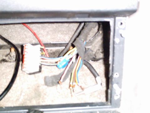 1986 Ford Bronco - A close-up view of a vehicle's internal wiring harness, showing a white connector and multiple colored wires.
