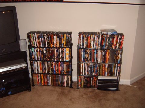 1988 Ford Bronco - Two tall shelves are packed with DVDs, positioned next to a television set and entertainment console.