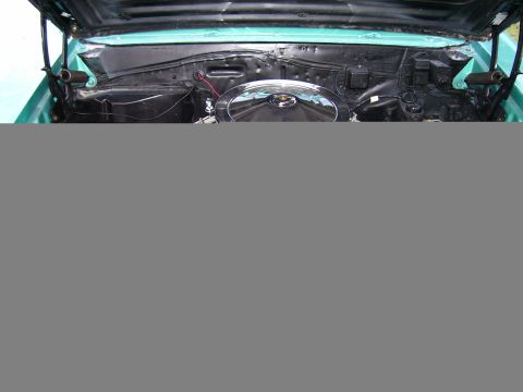 1967 Pontiac Lemans - The engine bay of a teal 1967 Pontiac Lemans shows a chrome air cleaner and organized wiring.