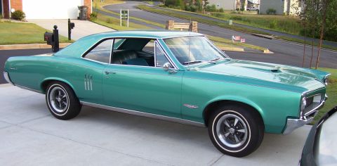 1967 Pontiac Lemans - This teal coupe features a distinctive hood scoop and triple side vents.