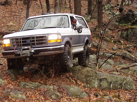 1995 Ford Bronco - This 1995 Ford Bronco navigates a rocky trail through a forest.