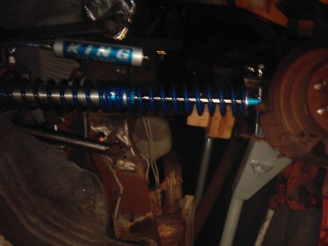 1978 Ford Bronco - Close-up of a King Off-Road shock absorber and blue coil spring assembly.