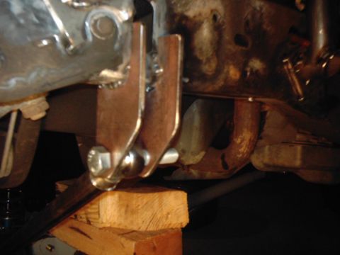 1978 Ford Bronco - Custom fabrication work is visible on the underside of a vehicle, with metal brackets attached to the frame.