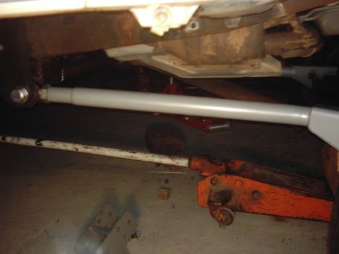1978 Ford Bronco - Vehicle underbody with suspension components and hydraulic jacks visible.