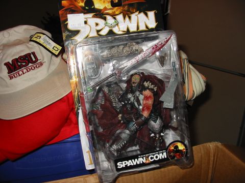 1991 Ford Bronco - A Spawn action figure is displayed in its packaging, alongside a baseball cap.