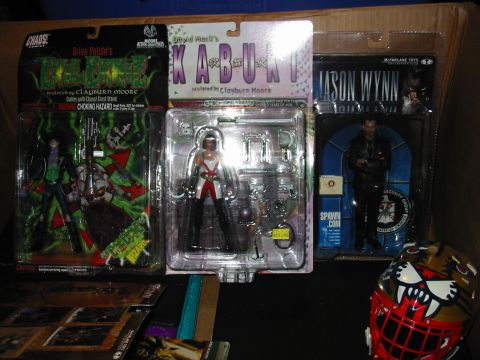 1991 Ford Bronco - A collection of action figures and a decorative helmet are displayed on a surface.