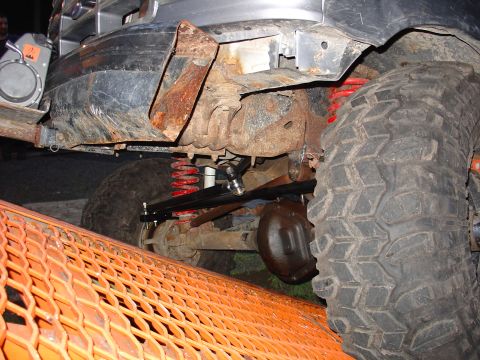 1995 Ford Bronco - Close-up of the undercarriage and suspension components of a modified off-road vehicle.