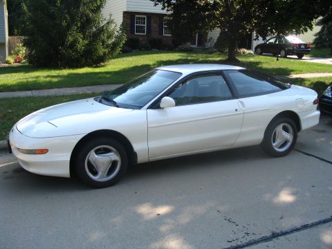 1997 Ford Probe - Side view of a white 1997 Ford Probe coupe parked on a paved driveway.