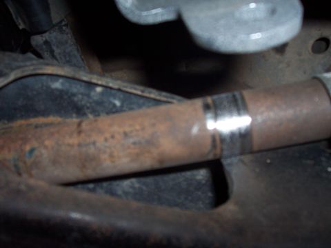 1996 Ford Bronco - Close-up of a rusty exhaust pipe with a clamp, showing signs of wear and tear.