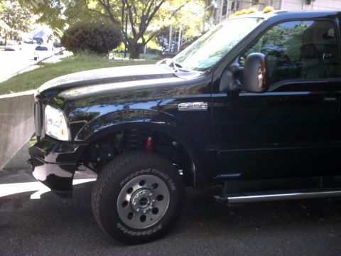 1995 Ford Bronco - Black Ford F-250 Super Duty truck is shown from the front three-quarter angle.