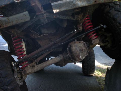 1995 Ford Bronco - The photo shows the undercarriage of a vehicle, focusing on the suspension and rear axle components.
