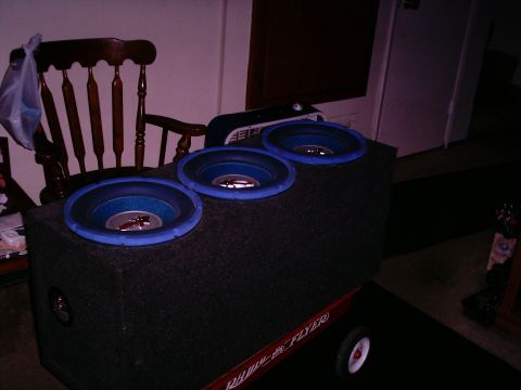 1986 Ford Bronco - A subwoofer box with three speakers is mounted on a Radio Flyer wagon.