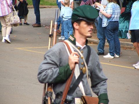 1966 Ford Ranchero - A man dressed in a Civil War reenactment uniform stands with a rifle slung over his shoulder.