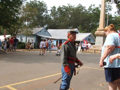 1966 Ford Ranchero - A reenactor in a Civil War uniform stands in a public area with other people and buildings.