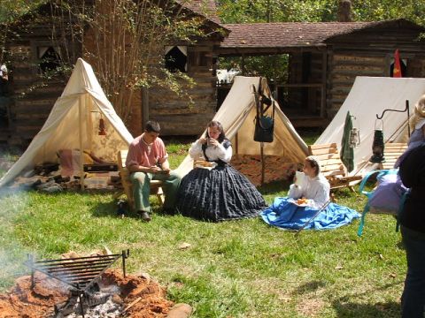 1966 Ford Ranchero - A historical reenactment depicts a Civil War encampment with tents and individuals dressed in period attire enjoying a meal outdoors.