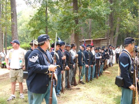 1966 Ford Ranchero - A group of reenactors dressed as Civil War soldiers stand at attention in a wooded area.