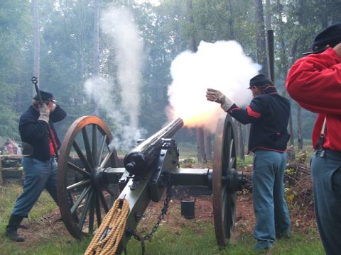 1966 Ford Ranchero - Men in historical uniforms fire a cannon during a reenactment event.