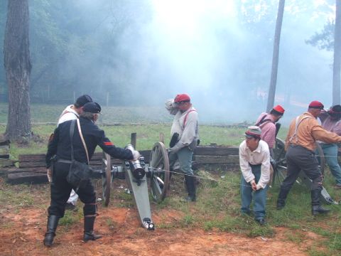 1966 Ford Ranchero - Men in period attire participate in a Civil War reenactment, preparing to fire a cannon.