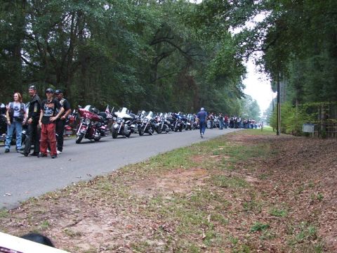 1966 Ford Ranchero - A large group of motorcycles are parked along a road, with people gathered around them.