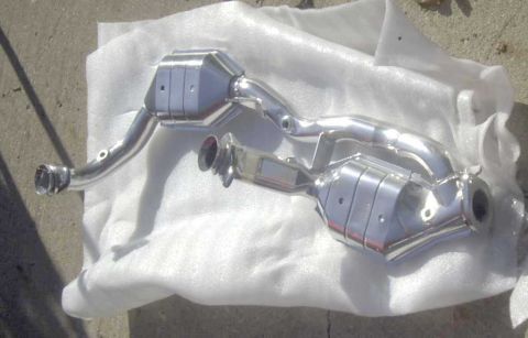 1997 Ford Taurus - New catalytic converter part shown unwrapped on white padding.
