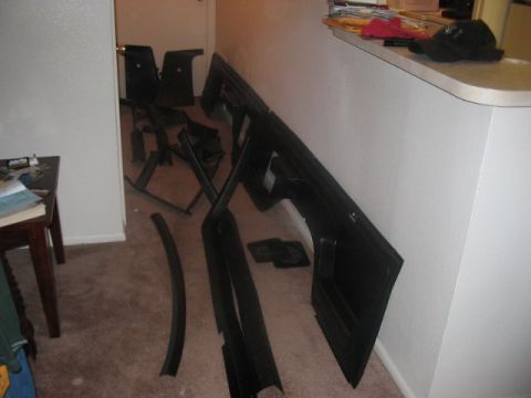 1991 Ford Bronco - Various disassembled car interior components are spread across the carpeted floor.