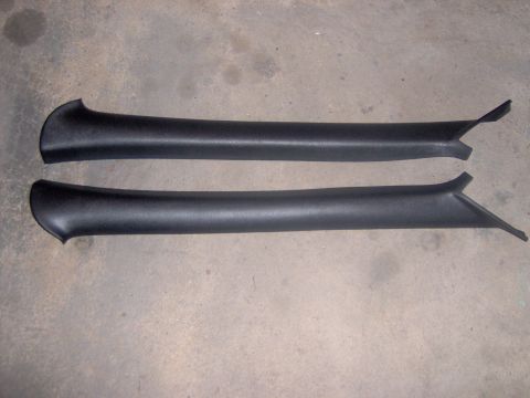 1994 Ford Probe - Two black plastic trim pieces are shown against a concrete background.