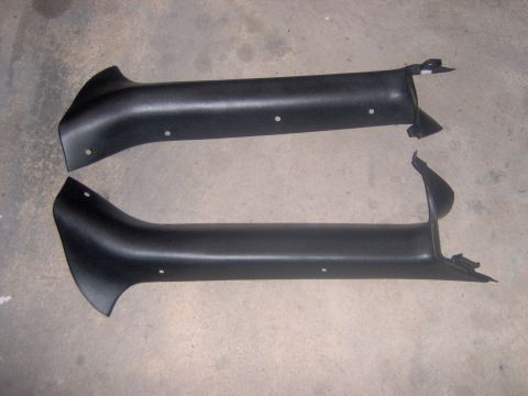 1994 Ford Probe - Pair of black plastic interior trim pieces shown on a concrete floor.