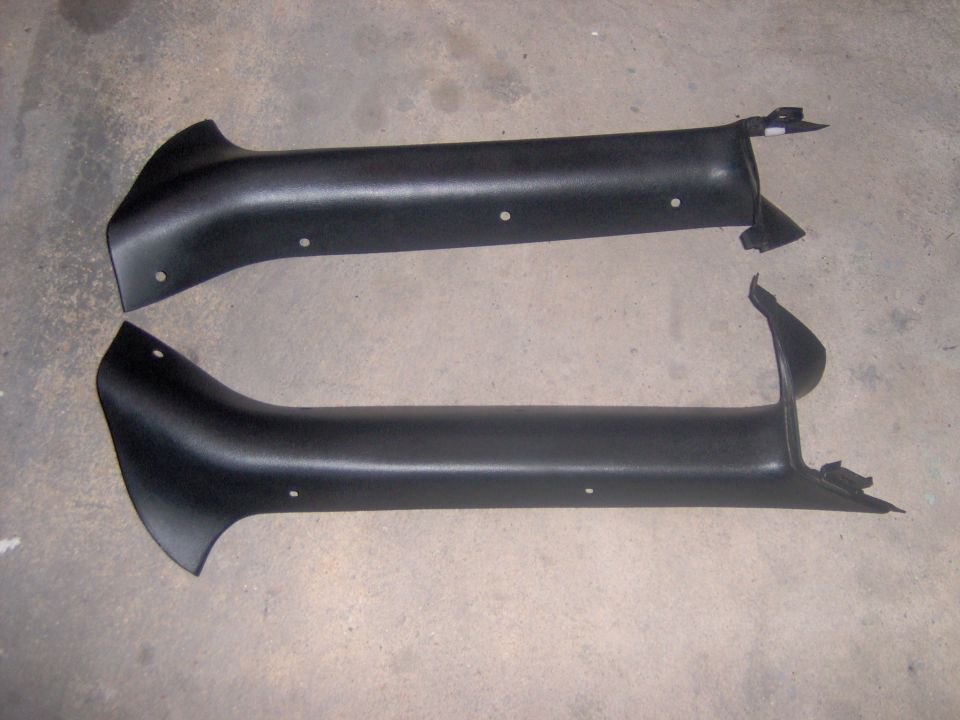 Two black plastic interior trim pieces, possibly A-pillar covers