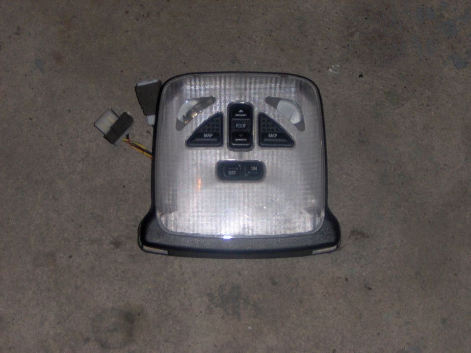 Overhead console with buttons labeled MAP, ROOF, OFF, and ON