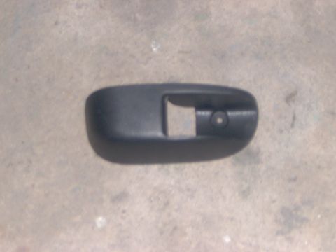 1994 Ford Probe - A black plastic interior trim piece is shown against a concrete background.