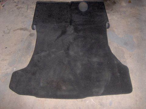 1994 Ford Probe - Car trunk carpet mat shown laid out on a concrete floor.