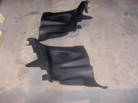 1994 Ford Probe - These two black plastic interior trim pieces are shown on a concrete floor, likely for sale or repair.