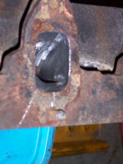 1967 Ford Mustang - Close-up of a corroded metal component, possibly from a vehicle's undercarriage.