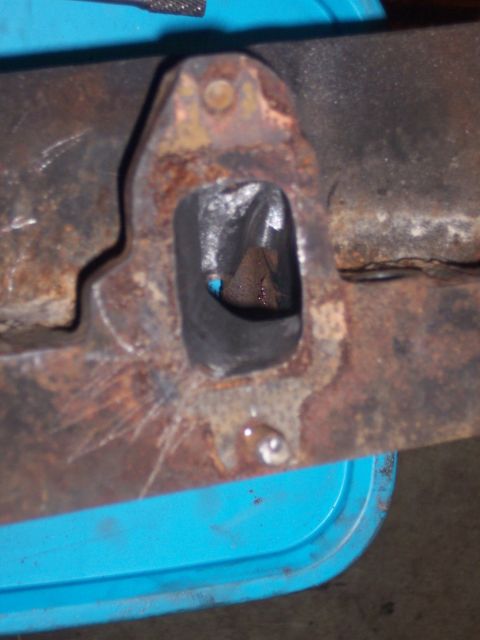 1967 Ford Mustang - Close-up of a heavily rusted exhaust manifold part, showing internal wear.