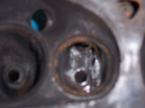 1967 Ford Mustang - This is a close-up view of an engine's cylinder head, revealing internal components and some wear.
