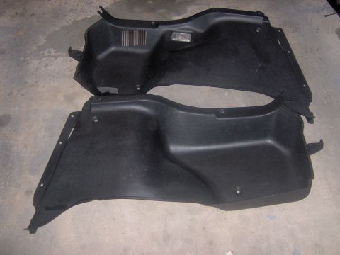 1994 Ford Probe - Black plastic interior trim panels are shown laid out on a concrete surface.