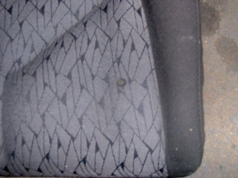 1994 Ford Probe - Gray car seat fabric with a diamond pattern is visible, along with a small stain.