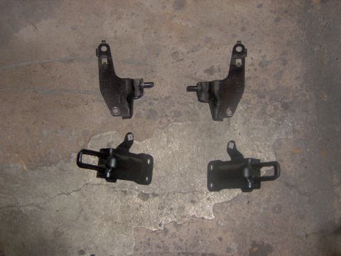 1994 Ford Probe - These are four car door hinges shown on a concrete floor.