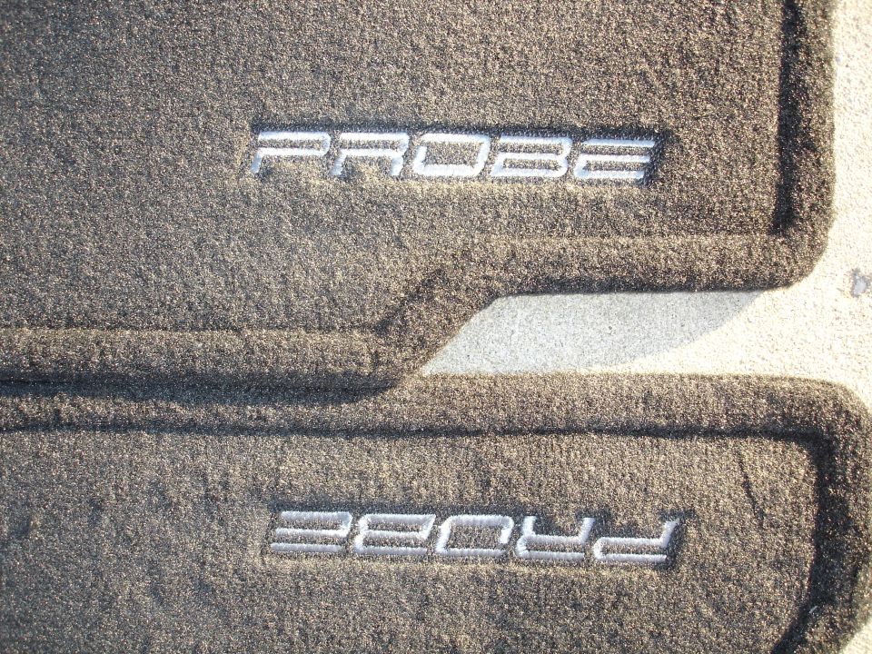 Two gray car floor mats with "PROBE" embroidered in silver lettering